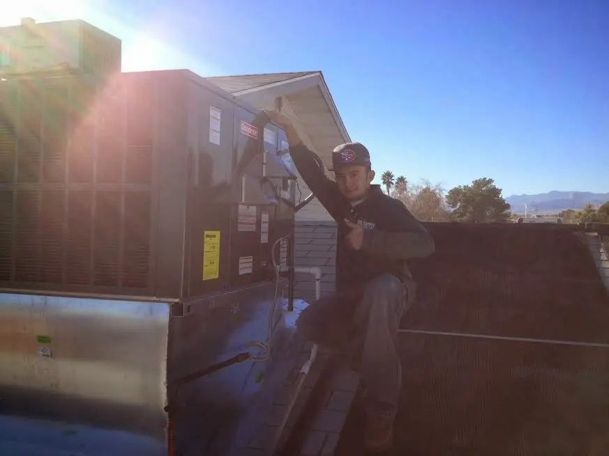 HVAC technician performing HVAC Inspection on a rooftop unit in Ridgefield